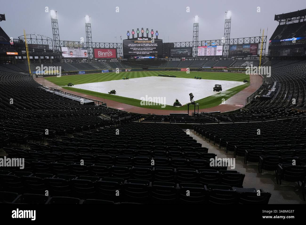 A tarp covers the infield during a rain delay before a baseball game ...