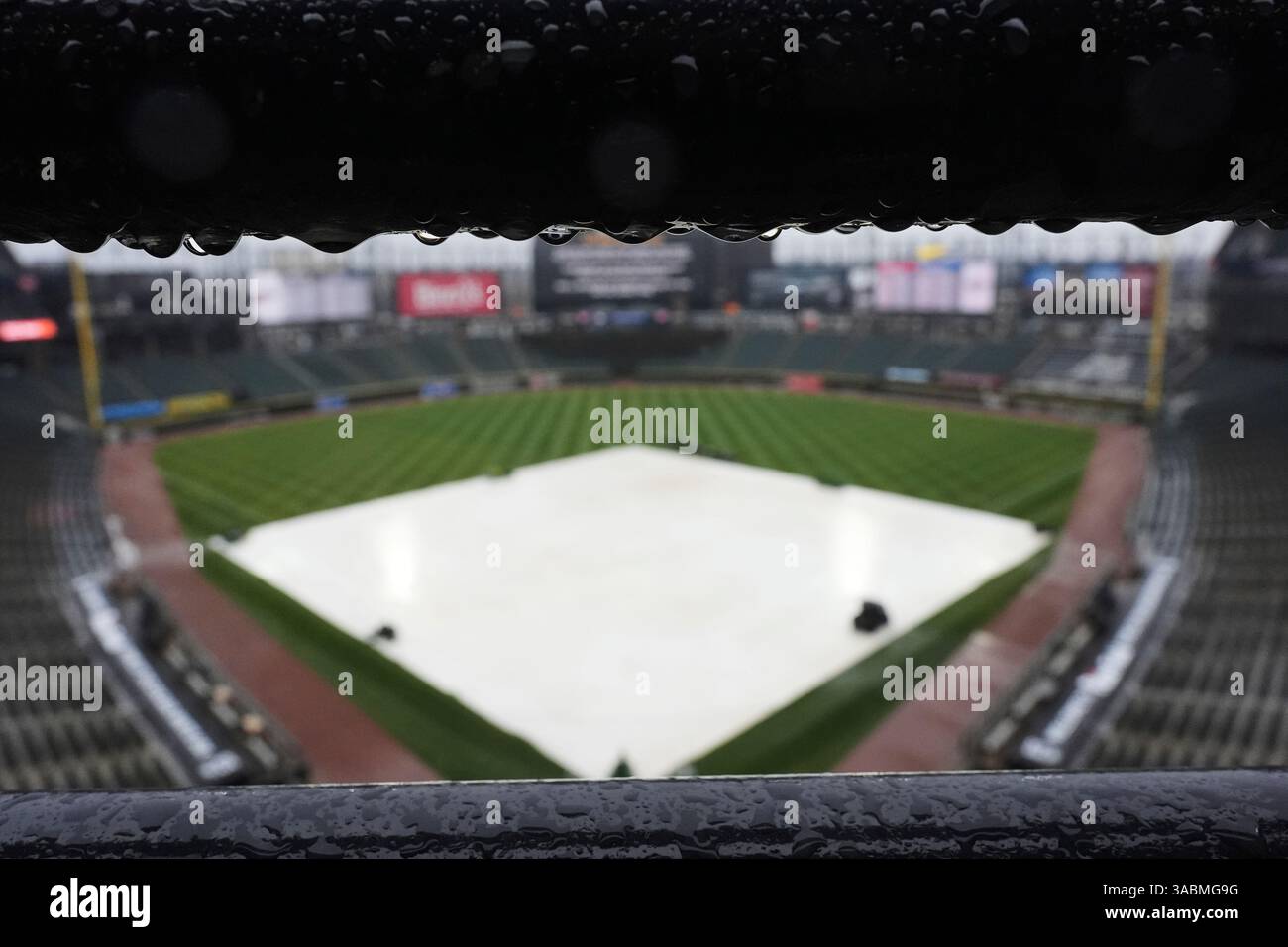 A tarp covers the infield during a rain delay before a baseball game ...