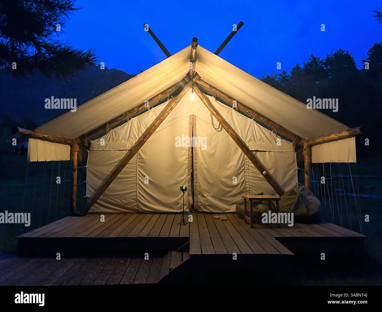 House tent with a light bulb at night - Smartphone Captured Stock Image