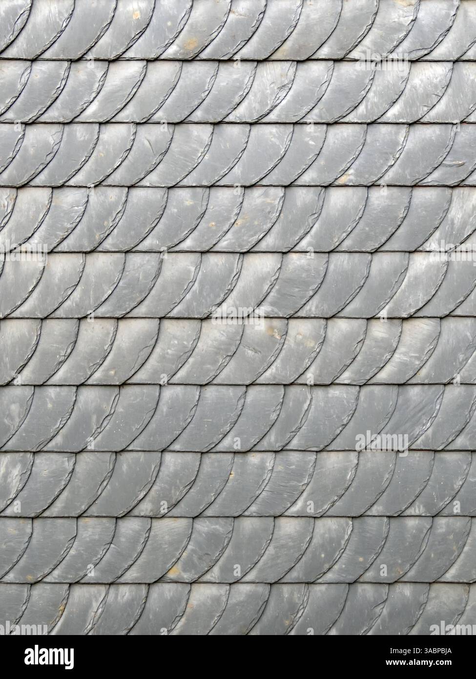 Gray slate shingles form a pattern on a facade, backgrounds Stock Photo