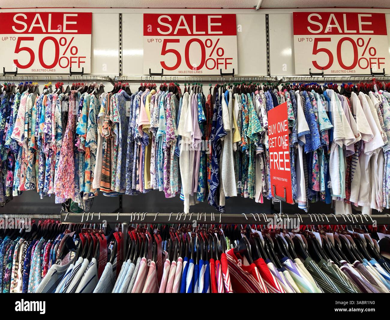 Clothes rails of discounted T shirts and long sleeved tops for men and women - Smartphone Captured Stock Image