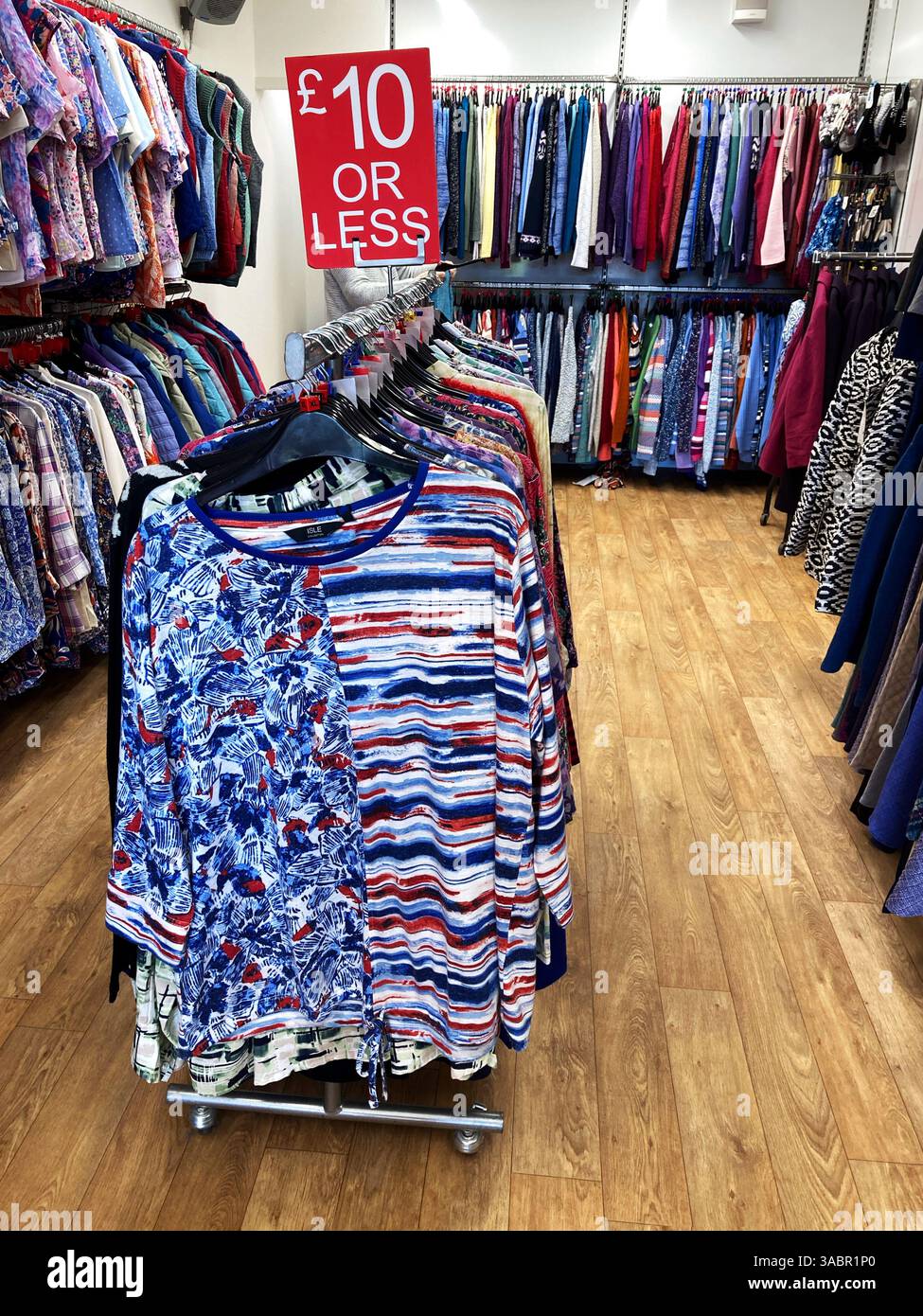 Clothes rails of discounted T shirts and long sleeved tops for men and women - Smartphone Captured Stock Image