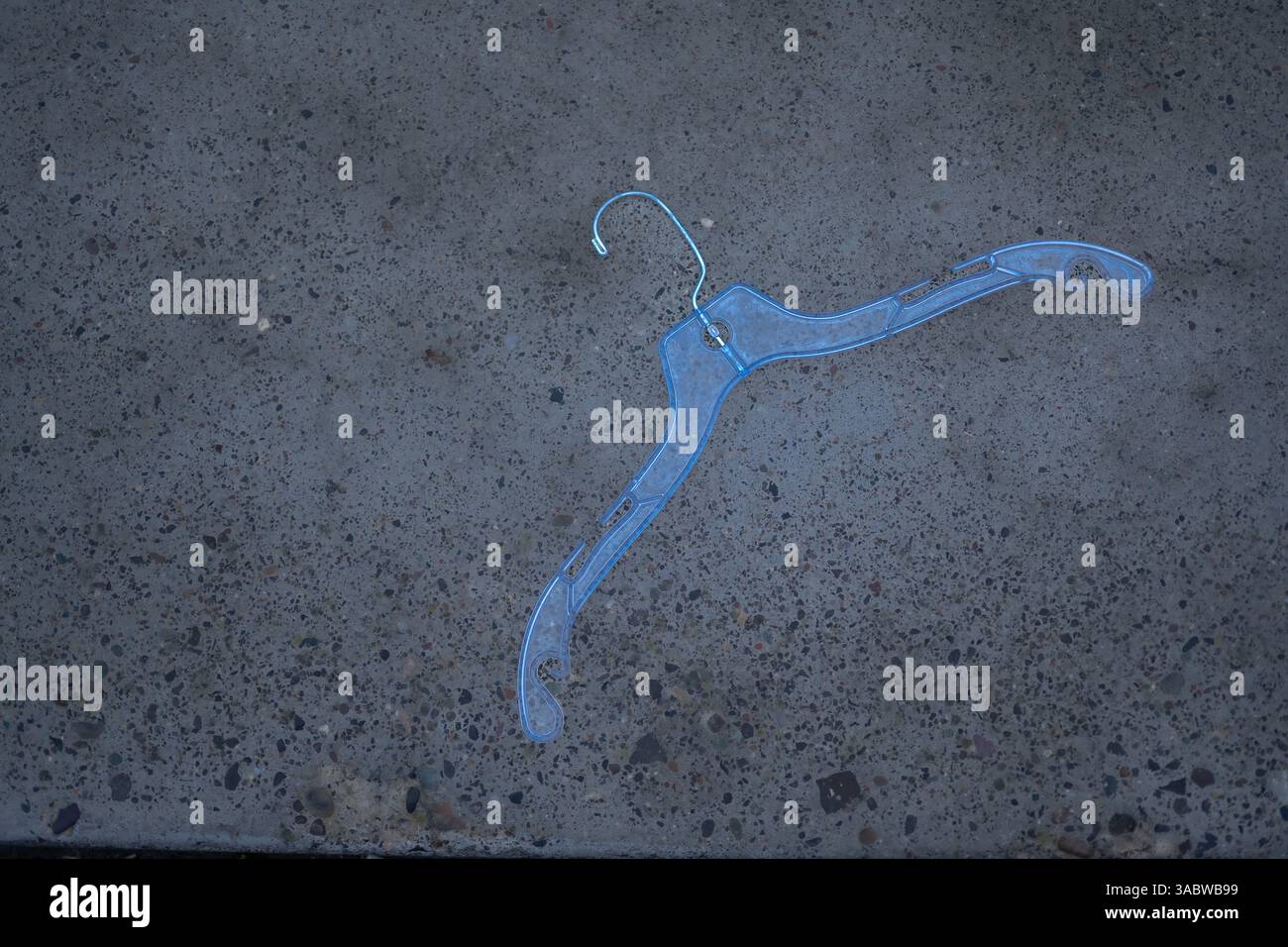 Blue Hanger on Grey Asphalt Stock Photo
