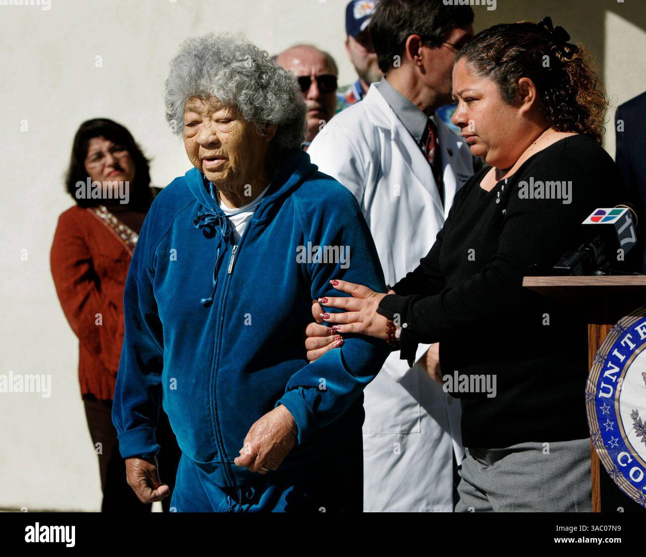 (Published 1/21/2006, A-14)  Judith Rosales Castillo, right, leads her grandmother Maria Vasquez, left, from the podium at a press conference after she spoke about how her grandmother has been mistakenly dropped from Medicare in January. The  press conference on the disasterous implementation of Medicare Part D, which is supposed to provide drug prescription benefits to seniors who are covered by Medicare, was held at Kimball Senior Center in National City.---Laura Embry/Union-Tribune Stock Photo