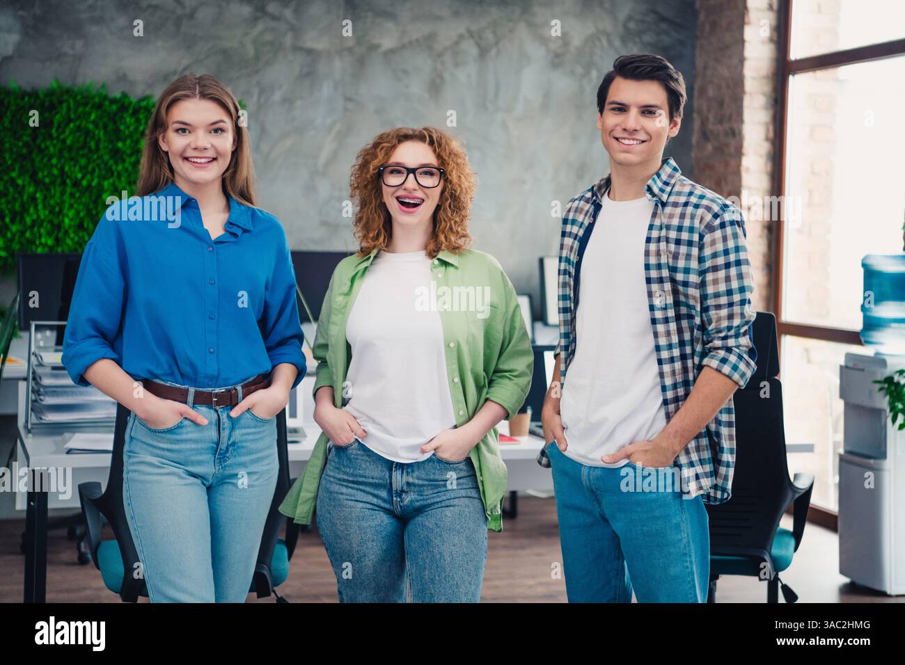 Group of young diverse coworkers standing together in a modern office ...