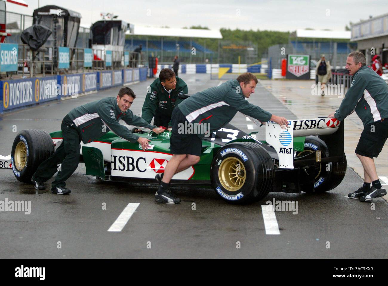 The Jaguar R4 with the new T3 livery is pushed back into the garage ...