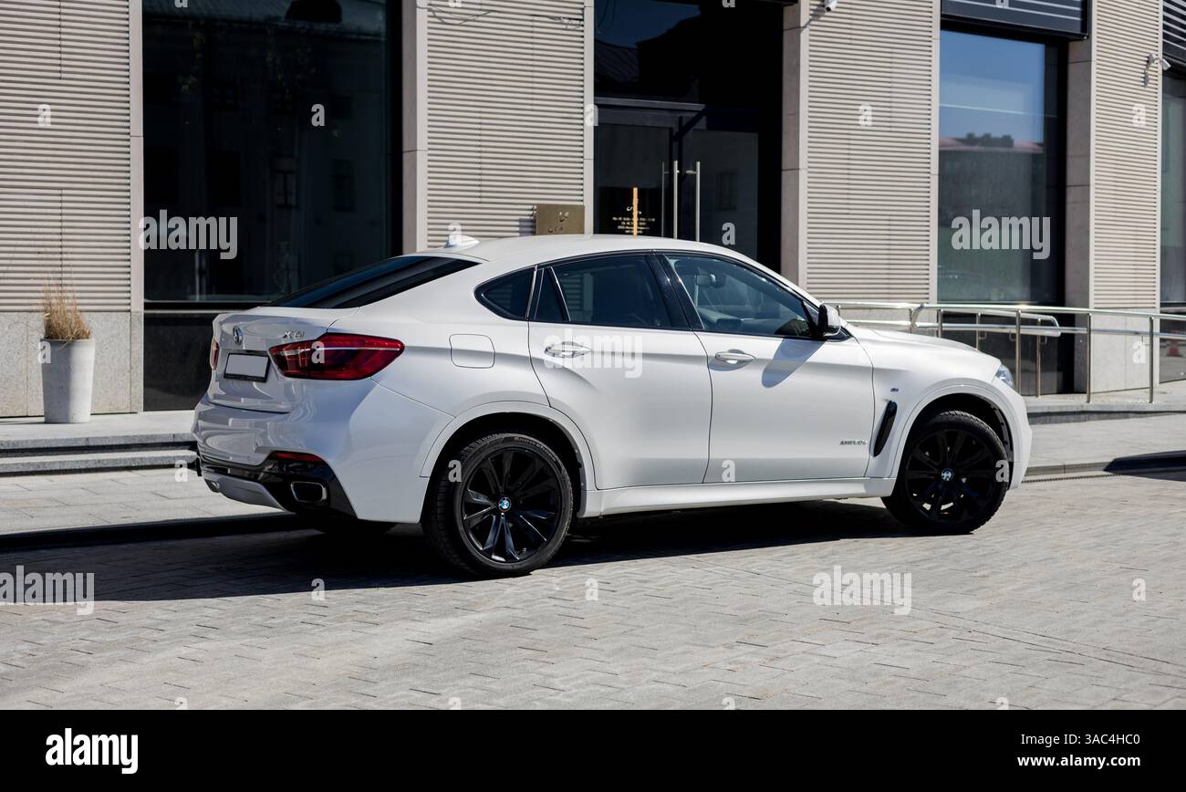 Minsk, Belarus, April 3, 2025 - Side view of white BMW X6 SUV parked on ...