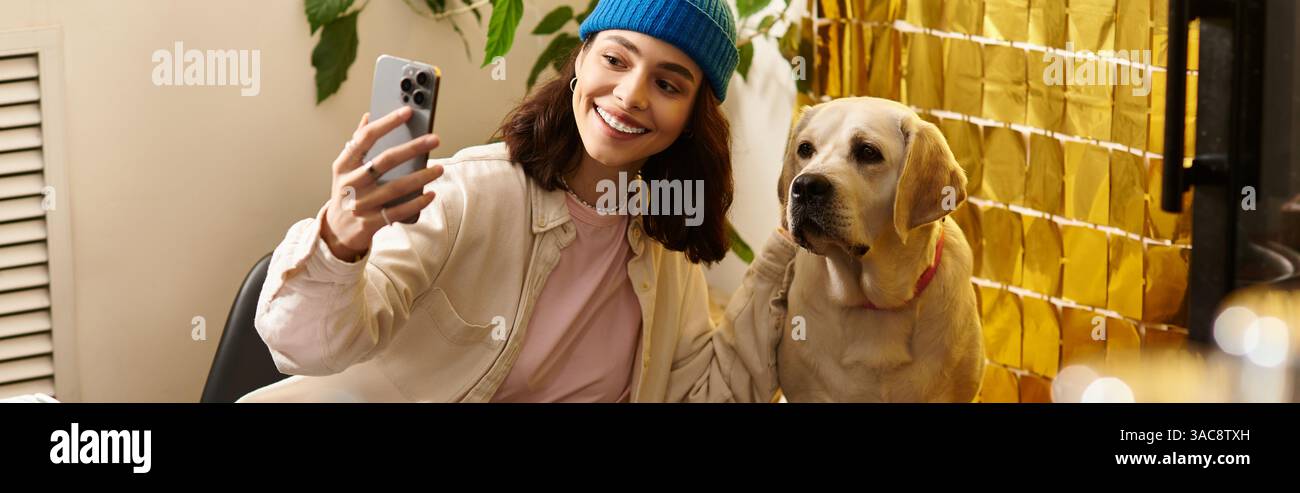 A cheerful young woman poses for a selfie with her labrador in a ...