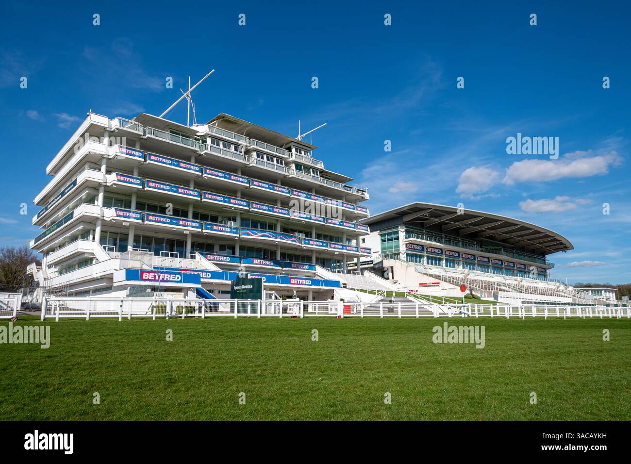 The Grandstand at Epsom Downs Racecourse in Surrey, England, UK, a thoroughbred horse racing course best known for hosting the Derby Stakes Stock Photo