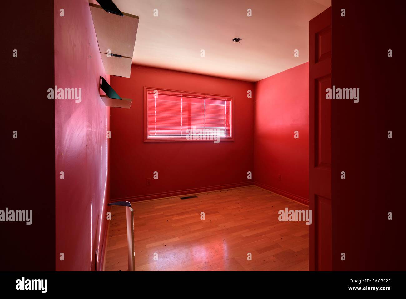 Abright red bedroom. This house has since been demolished Stock Photo