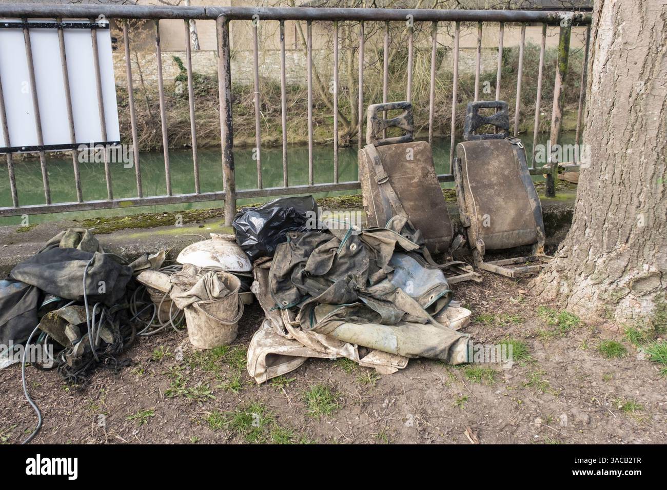 Car seats and various fly tipped items of rubbish pulled out of the river avon bath uk Stock Photo