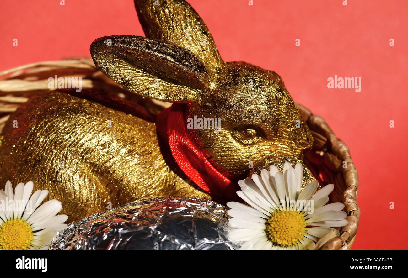 Easter Bunny with Silver Egg in Baske Stock Photo