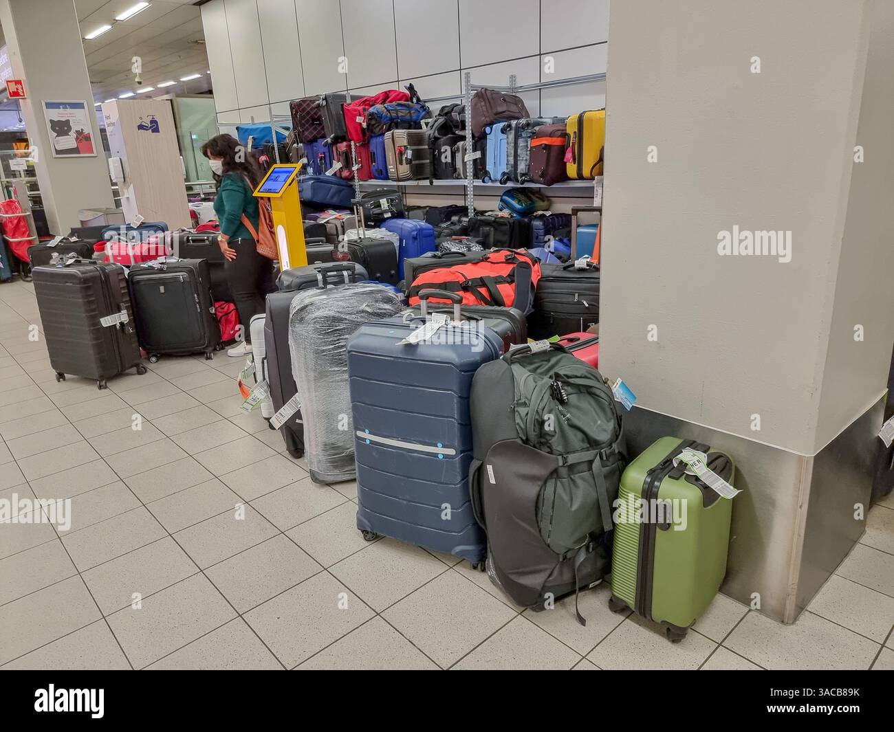 Piles of delayed baggage / lost luggage / suitcases in storage at Amsterdam Airport - Smartphone Captured Stock Image