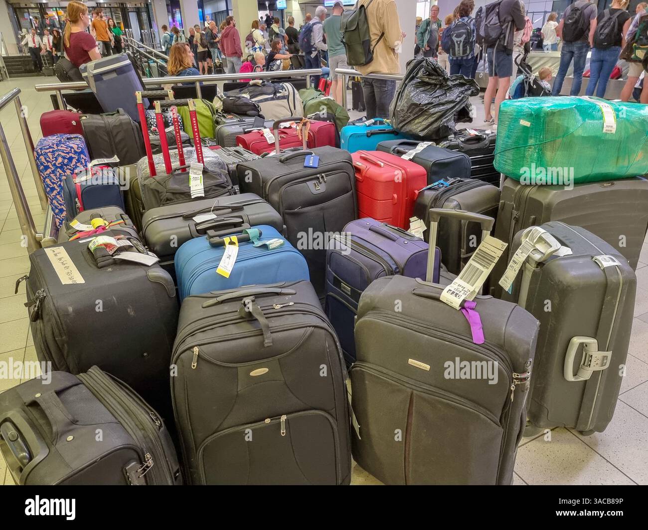 Piles of delayed baggage / lost luggage / suitcases in storage at Amsterdam Airport - Smartphone Captured Stock Image