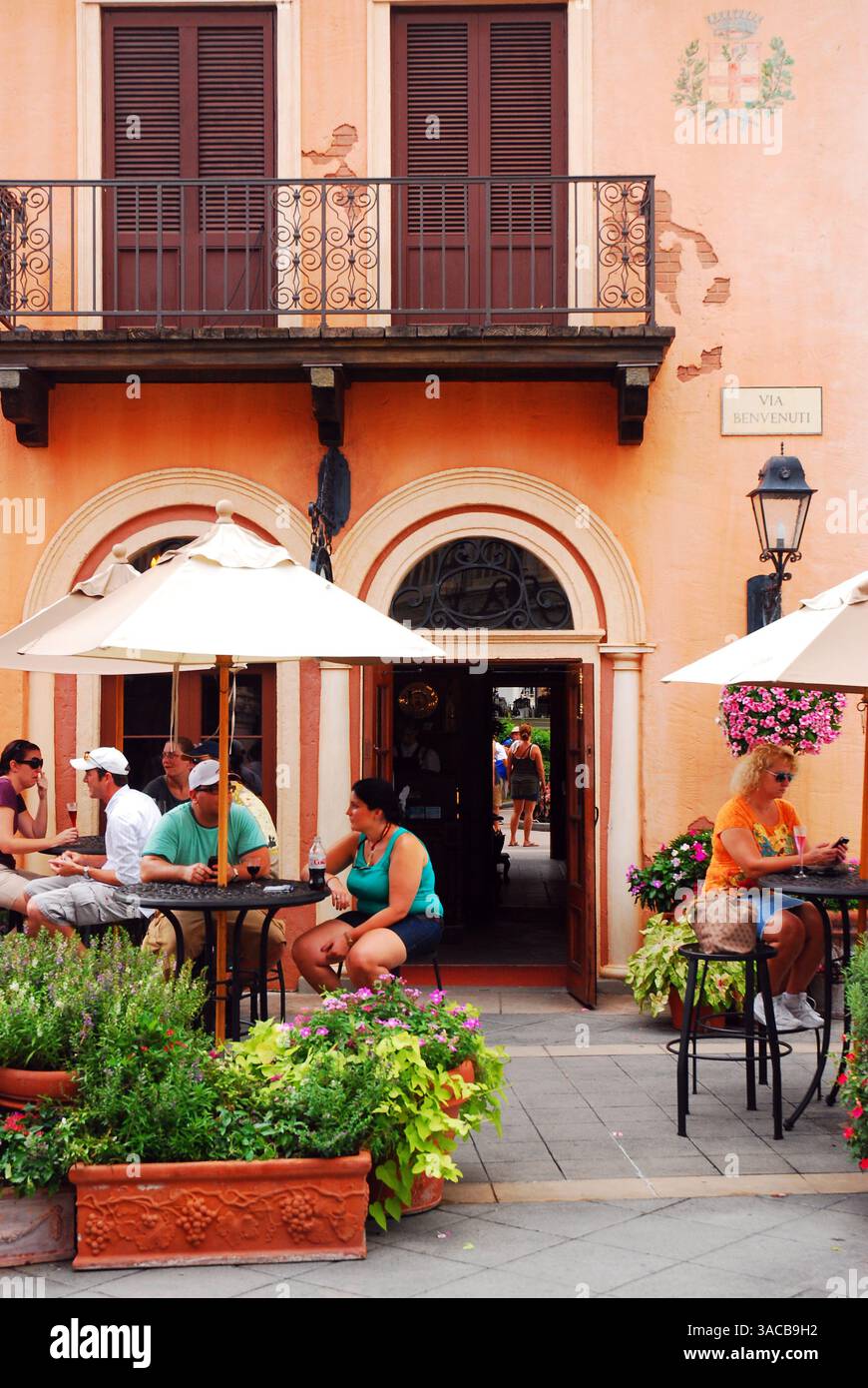 People enjoy sitting and relaxing at an Italian style outdoor café in Disney World's Epcot Center in Orlando Florida Stock Photo