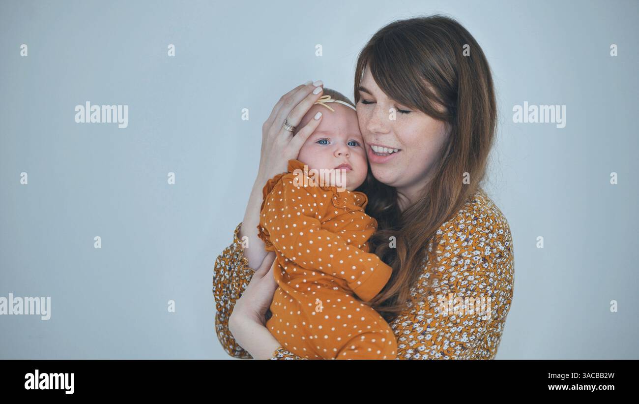 Nurturing mother embracing newborn daughter, sharing intimate bond ...