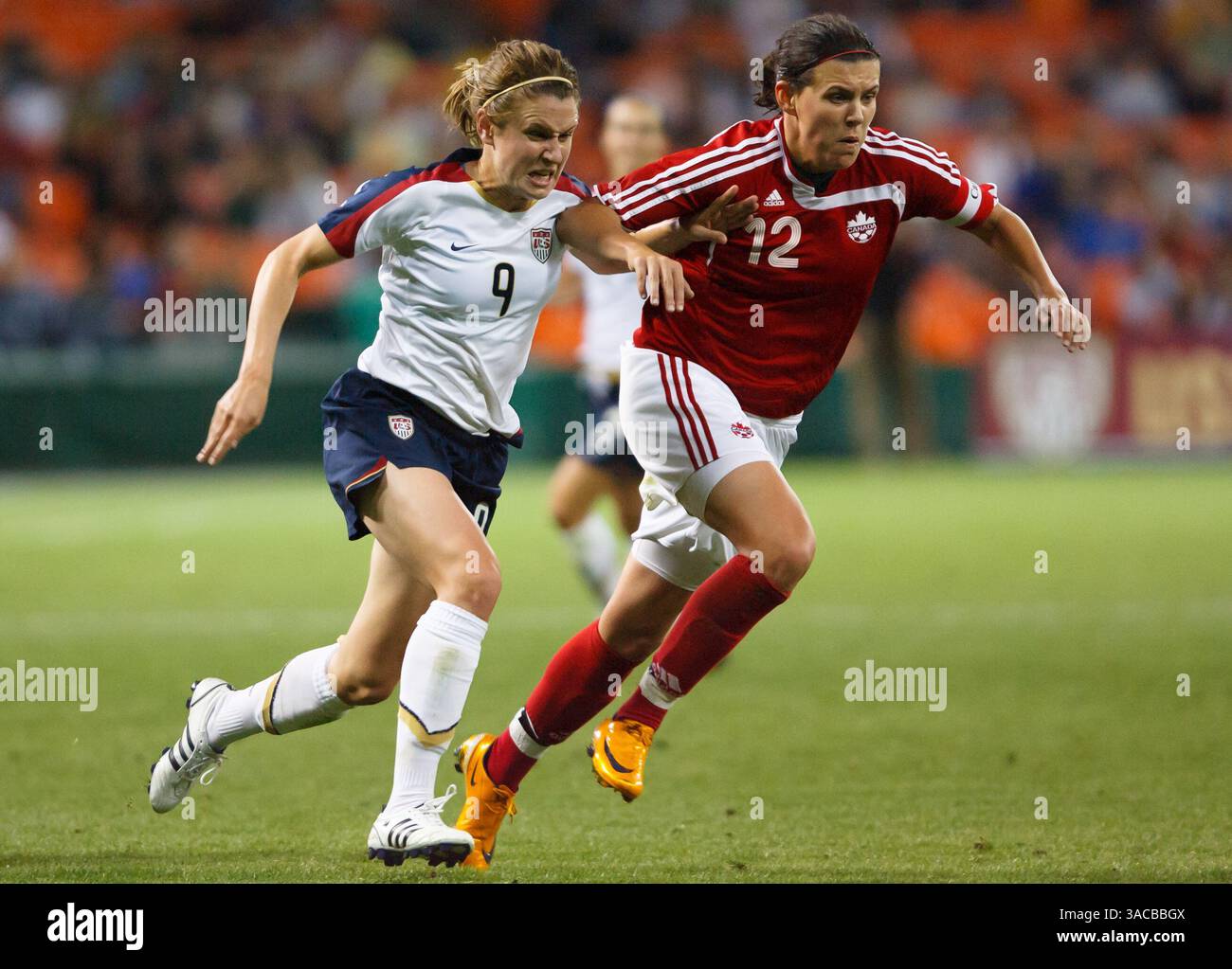 Heather O'Reilly of the United States (9) battles Canada Team Captain Christine Sinclair (12) during an international friendly match at RFK Stadium on May 10, 2008 in Washington, DC. Editorial use only. Commercial use prohibited. (Photograph by Jonathan Paul Larsen / Diadem Images) Stock Photo