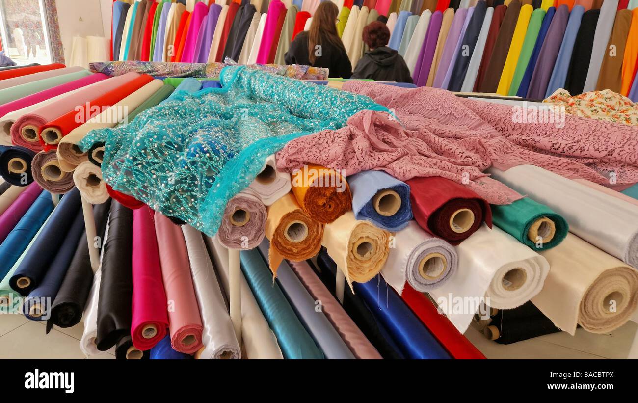 Women shopping in a colorful fabric store - Smartphone Captured Stock Image