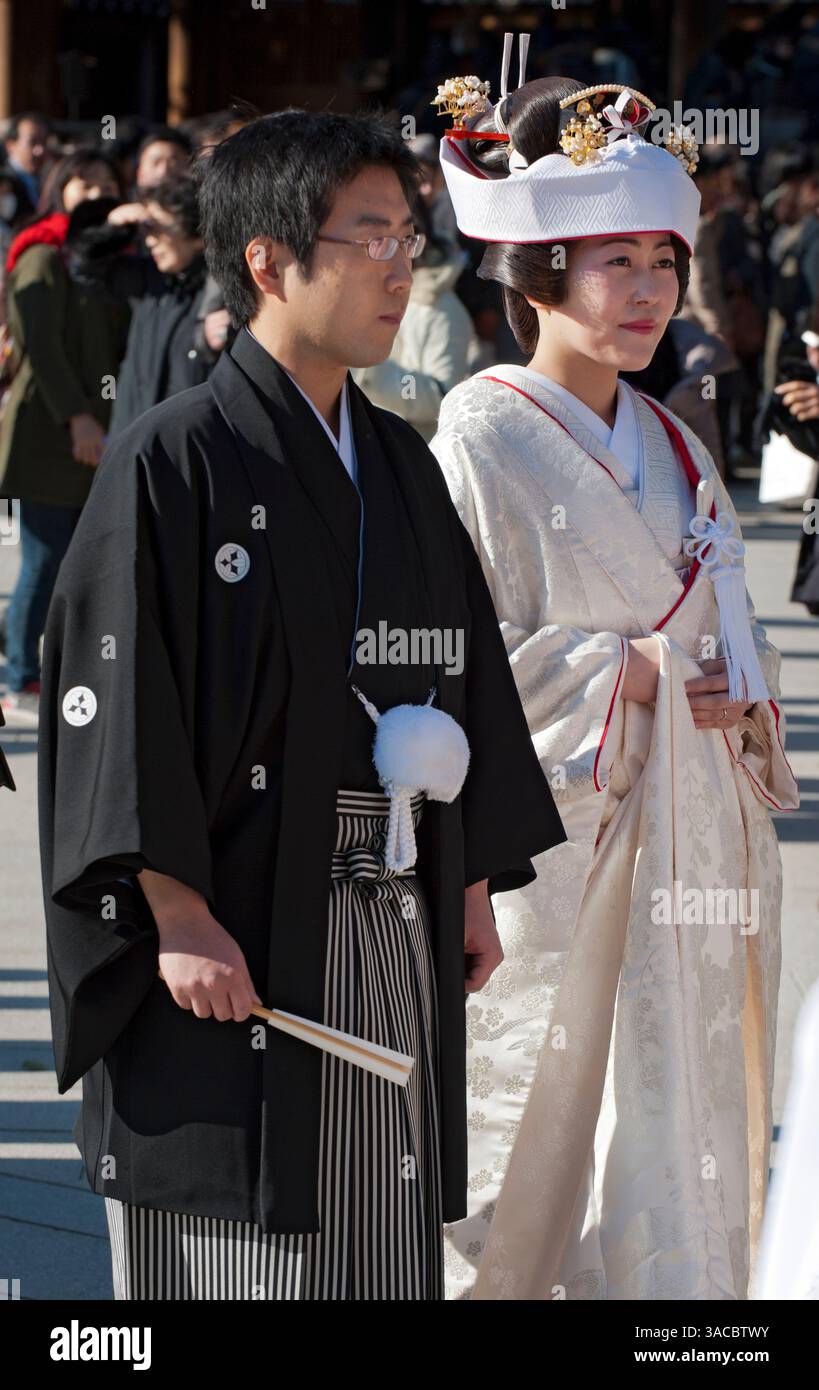 A bride and groom dressed in traditional Japanese wedding kimono partake in a formal Shinto wedding ceremony at Meiji Jingu shrine in Tokyo, Japan. Stock Photo