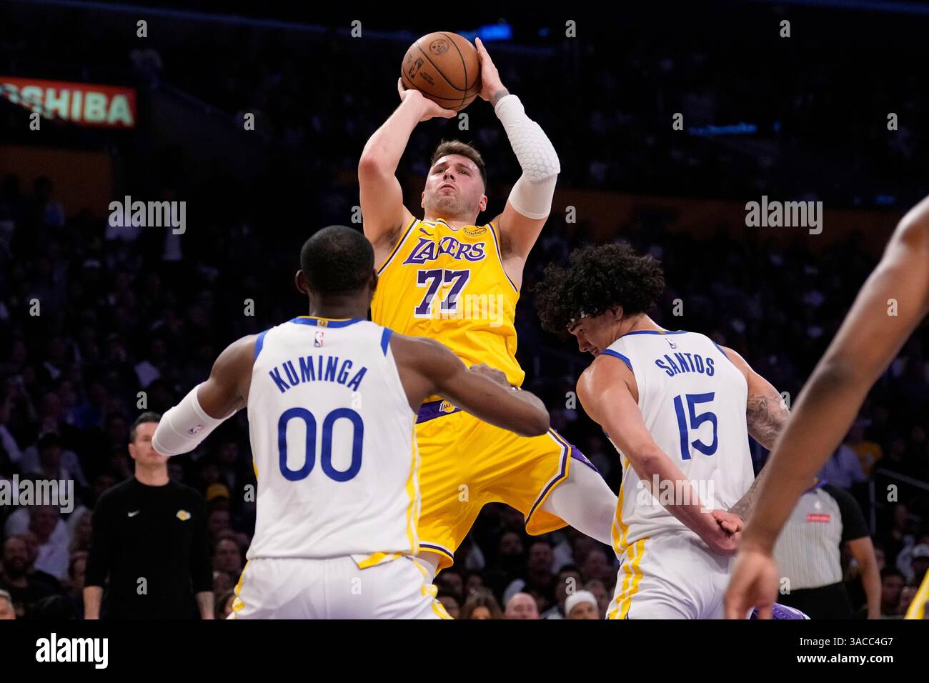 Los Angeles Lakers guard Luka Doncic, center, shoots as Golden State