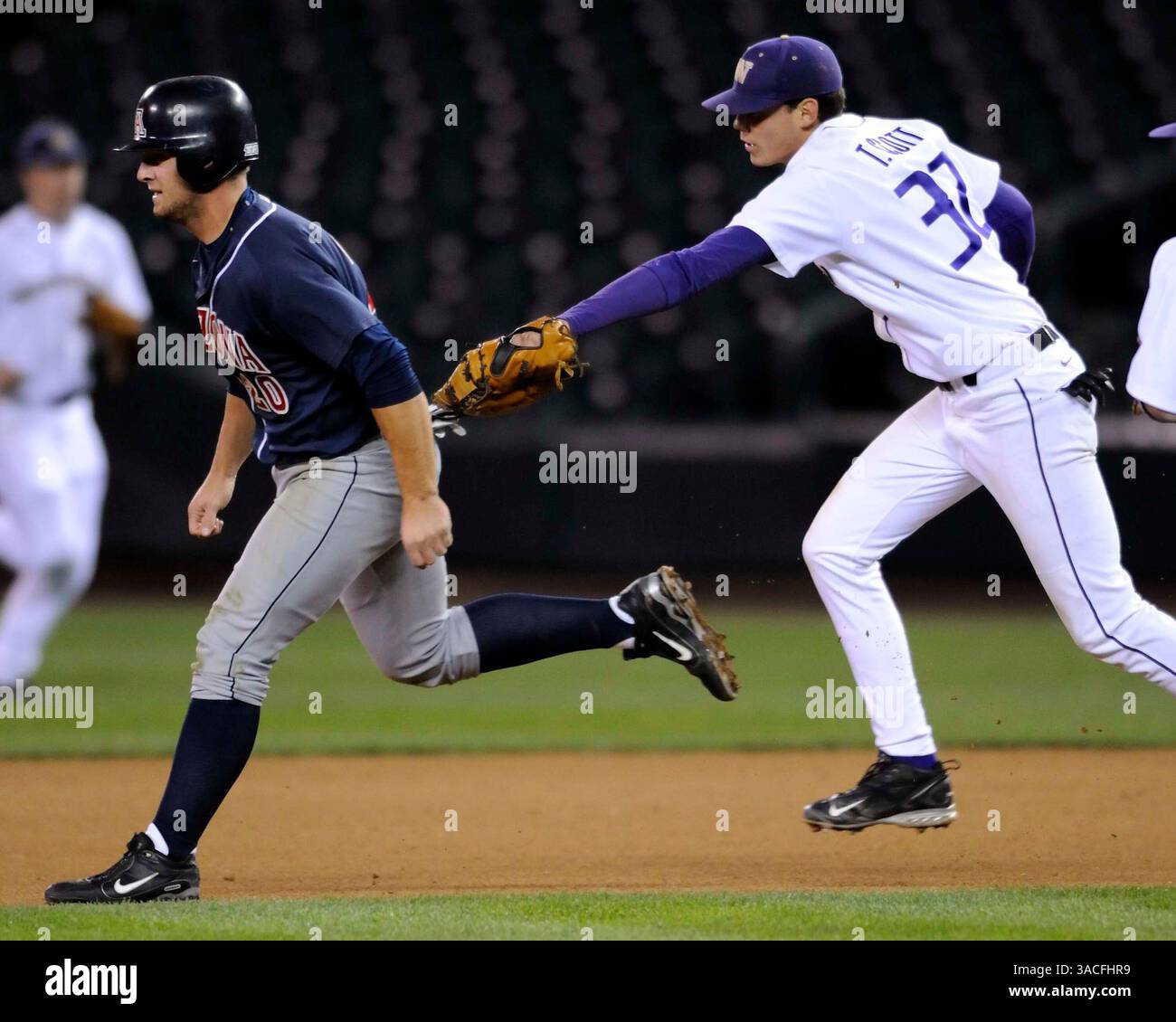 April 4th, 2008 - Seattle, WA.First Baseman Troy Scott #32 of Washington tags out Brad Glenn #20 of Arizona in a run down Saturday at Safeco Field in Seattle..Washington defeats Arizona 1-0.George Holland / Cal Sport Media. (Credit Image: © Cal Sport Media/ZUMA Press) Stock Photo