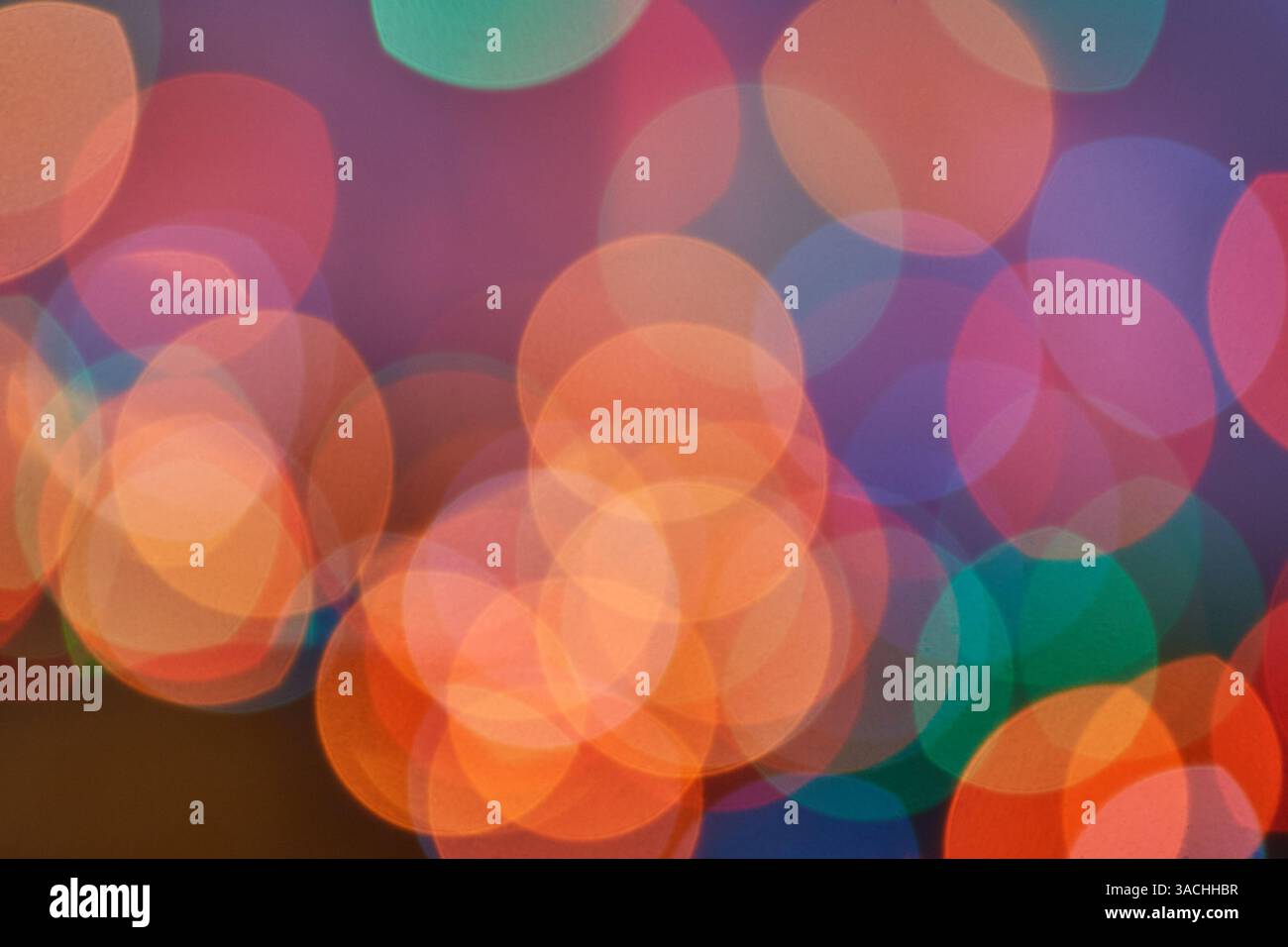 Colorful abstract bokeh lights in soft focus creating a vibrant and dreamy atmosphere. Stock Photo