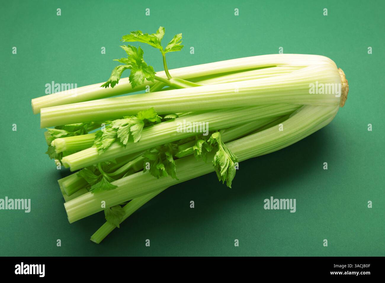 Fresh celery on dark green background. Top view Stock Photo