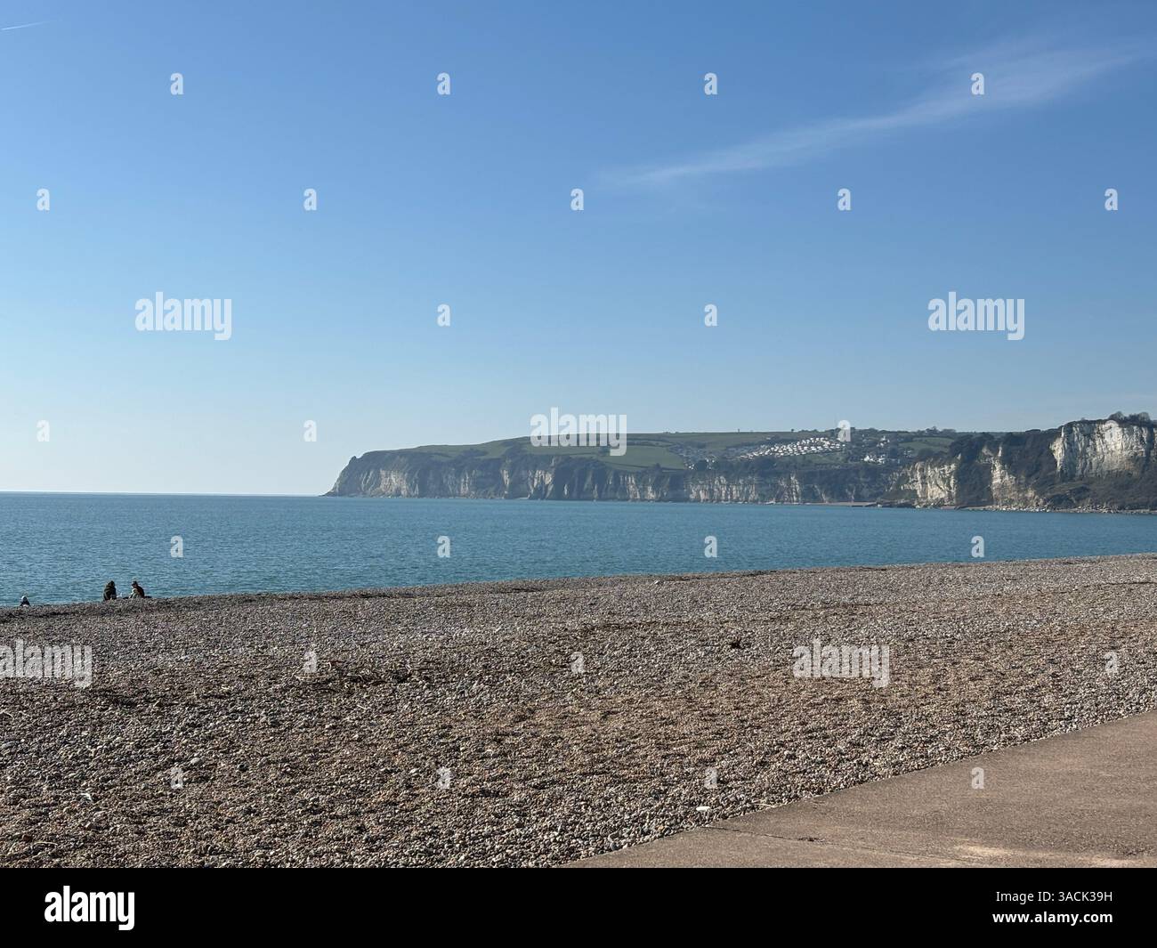 Pebble Beach Seaton with the Cliffs in the background in the spring 2025 - Smartphone Captured Stock Image
