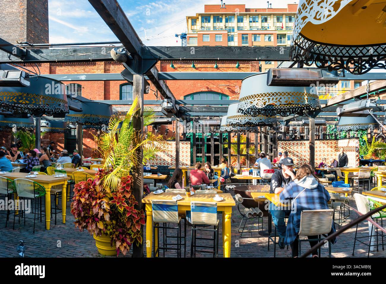 People dine at a restaurant in the Distillery District of downtown Toronto, Ontario, Canada. Stock Photo