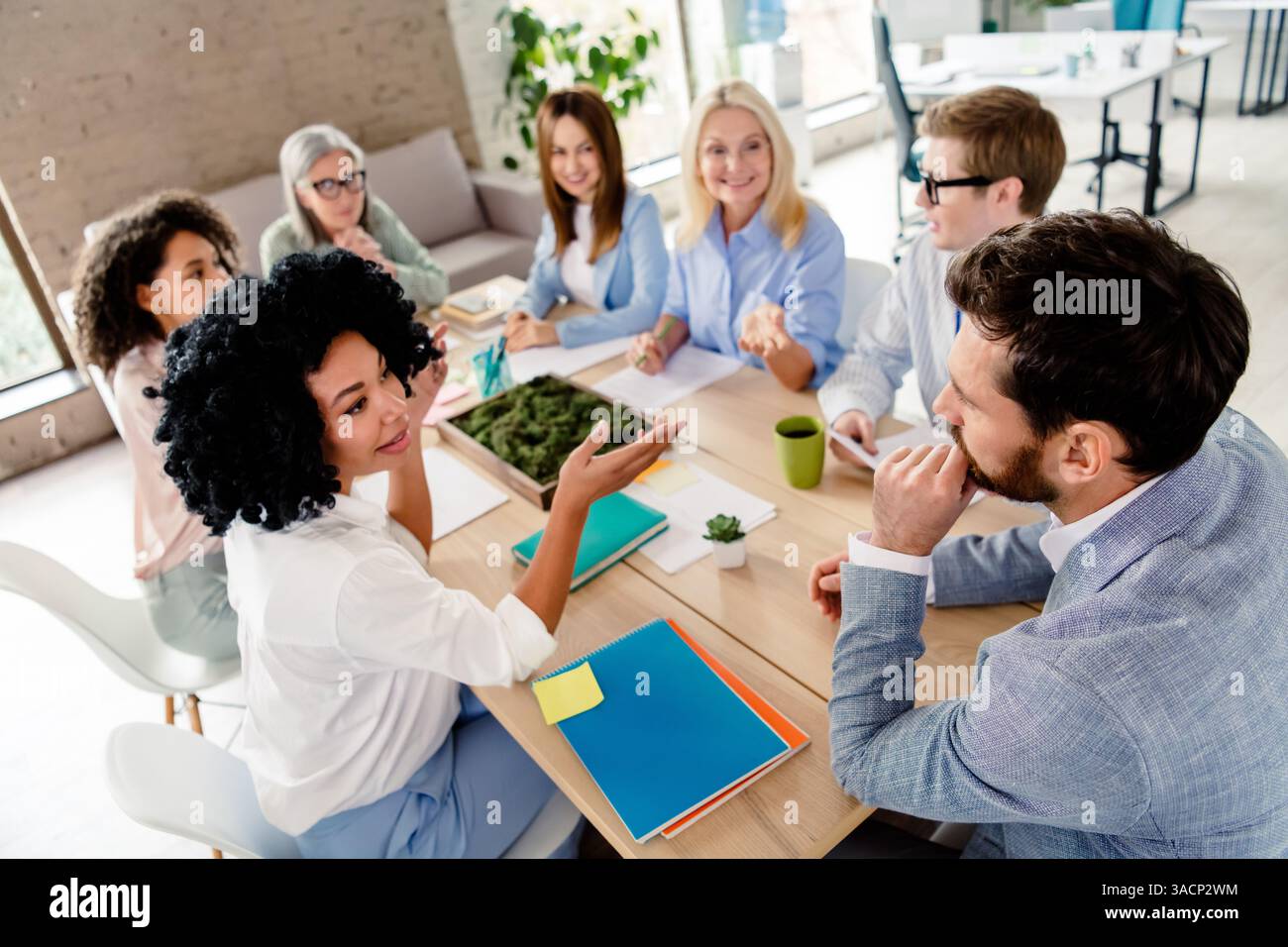 Diverse Team Collaborating in a Modern Office Setting Stock Photo - Alamy