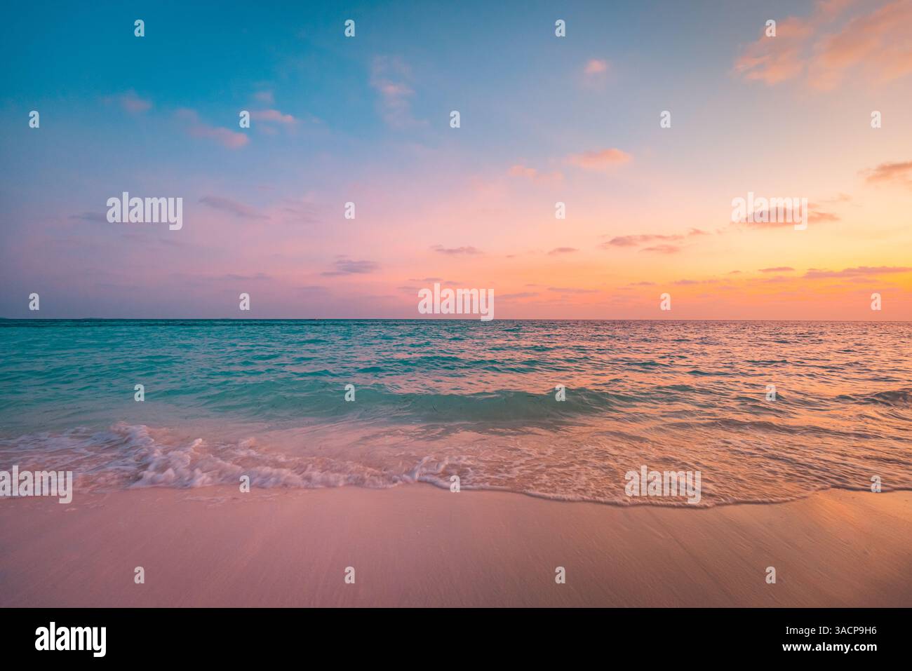 Tropical beach at sunset, vibrant skies reflecting on calm water sand, gentle waves splash shore, serene atmosphere under colorful sky, peaceful sea Stock Photo