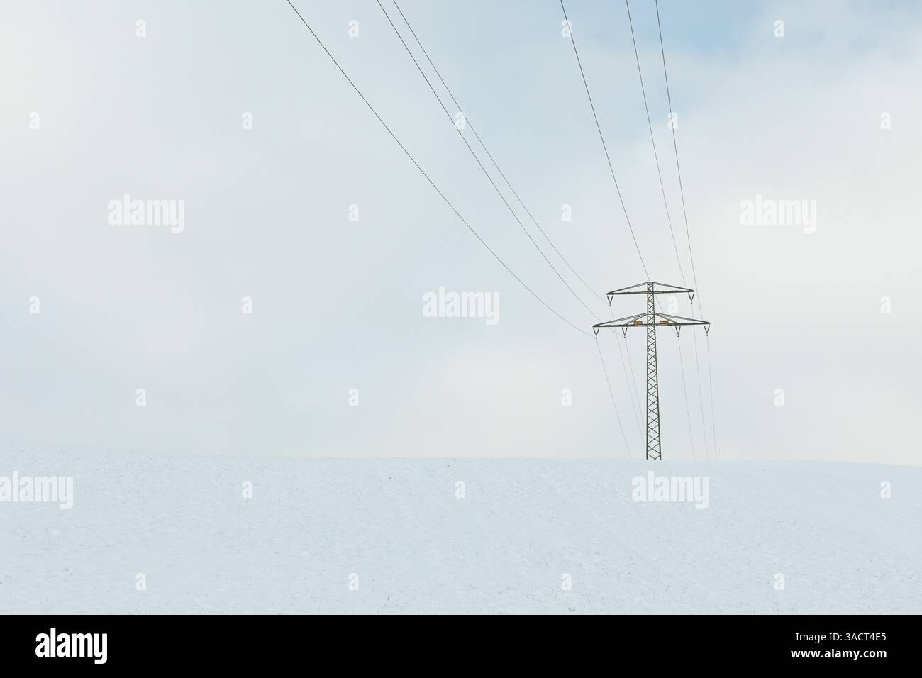 Single high-voltage pylon in winter Stock Photo - Alamy