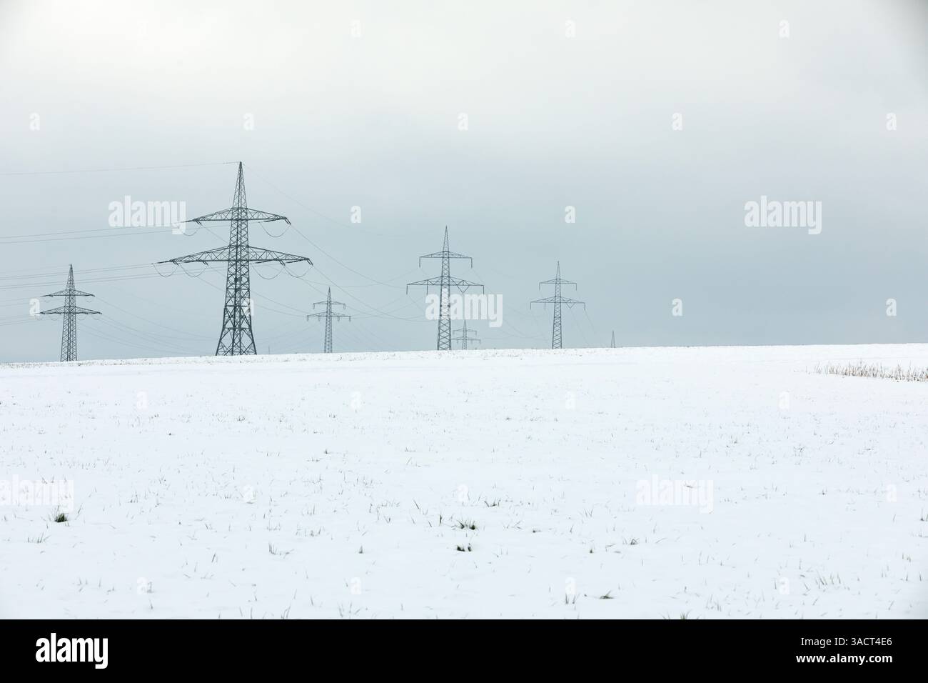 High-voltage pylons in winter Stock Photo - Alamy