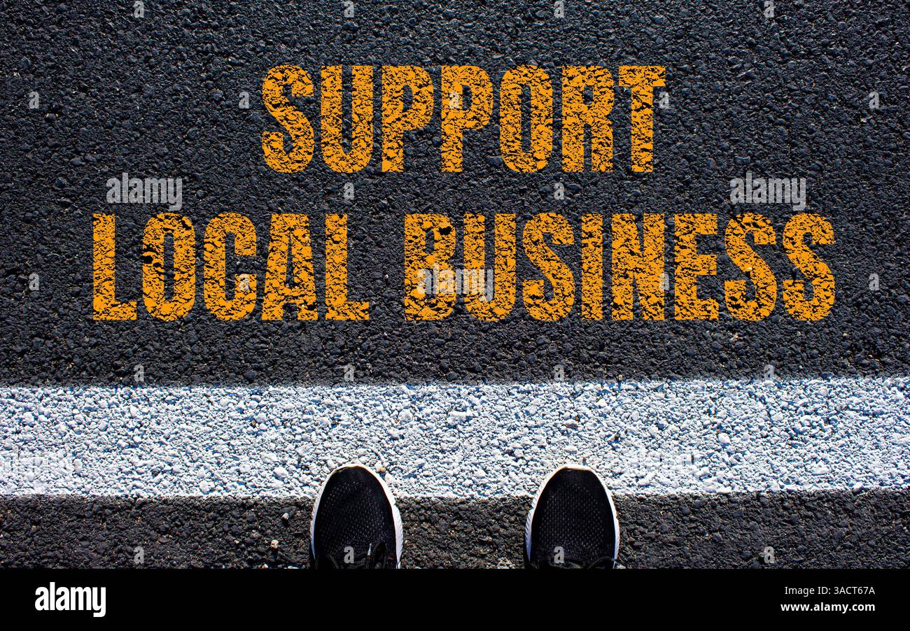 Support local business message written on asphalt road. Conceptual ...