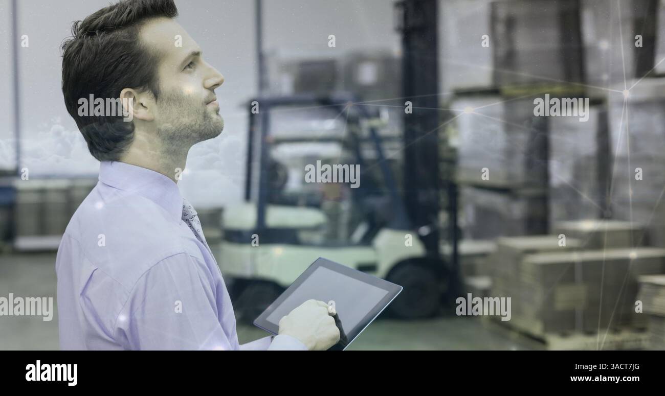 Warehouse manager using tablet to oversee inventory and logistics operations Stock Photo
