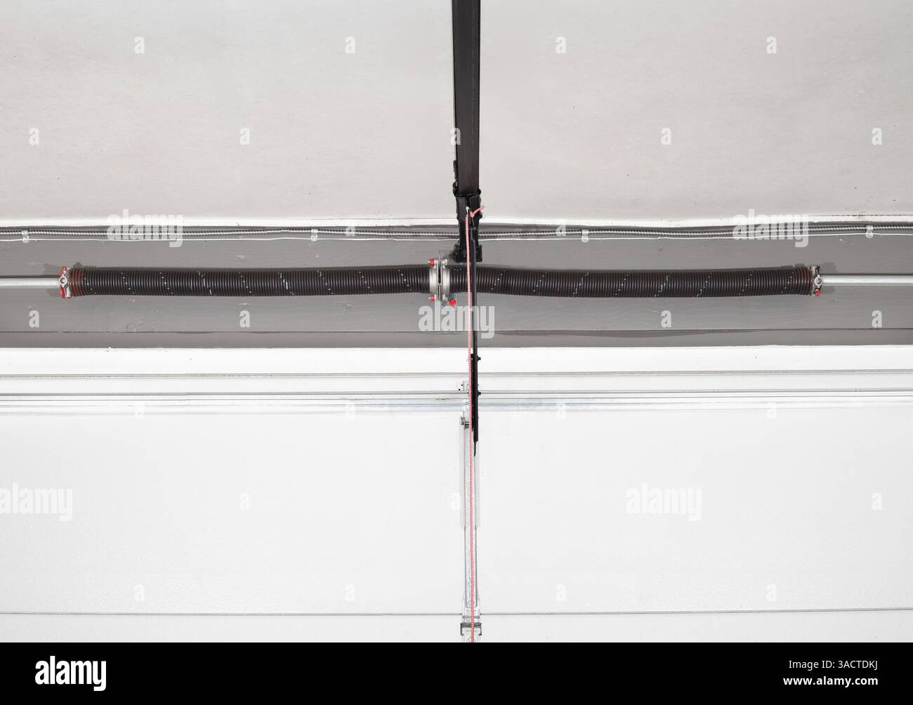Overhead sectional door mechanism or components. Close up of torsion