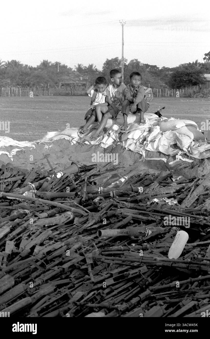 Problem Solving Weapon Dec 11, 2003; Preah Vihear, CAMBODIA; Children sitting next to a pile ...