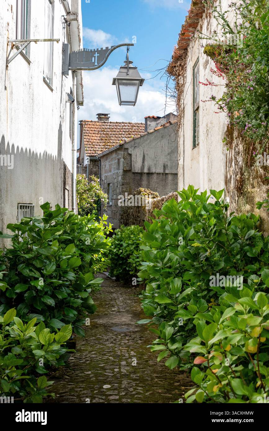 Picturesque medieval narrow alleyway in the center of Tracoso, showing alley Rua dos Mercadores, Portugal Stock Photo