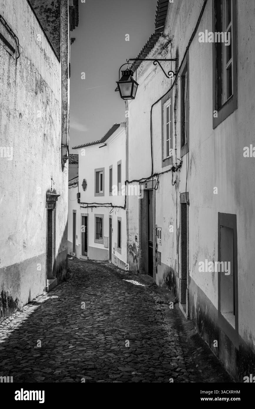 Picturesque abandoned Freiria de Cima alley in the medieval city center of Evora, Portugal Stock Photo
