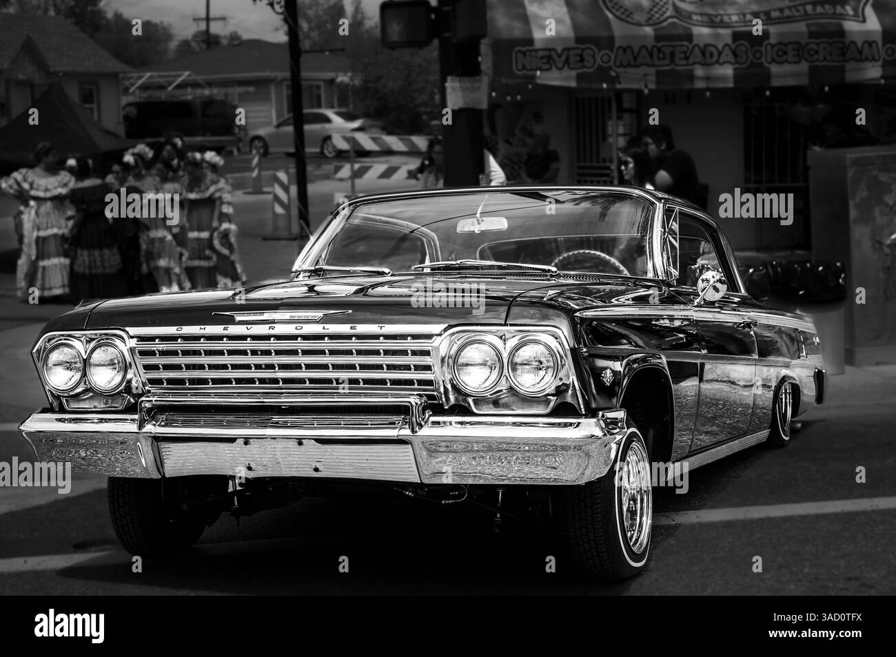 Classic Lowrider Car in a Vintage Urban Festival Setting Stock Photo