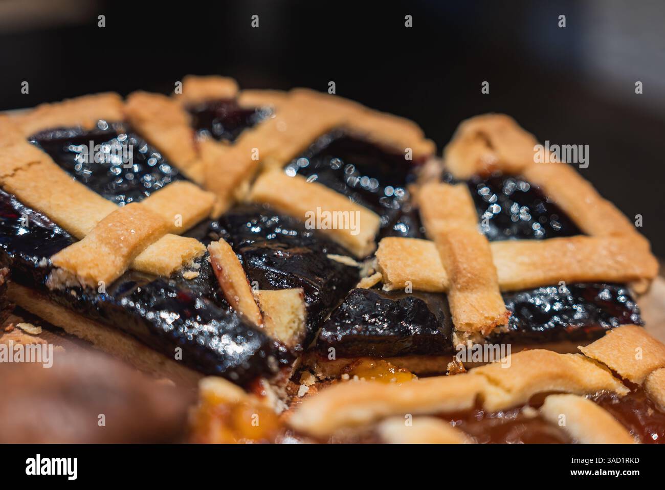 Close Up of a Lattice Topped Pie with Glossy Dark Fruit Filling Stock Photo