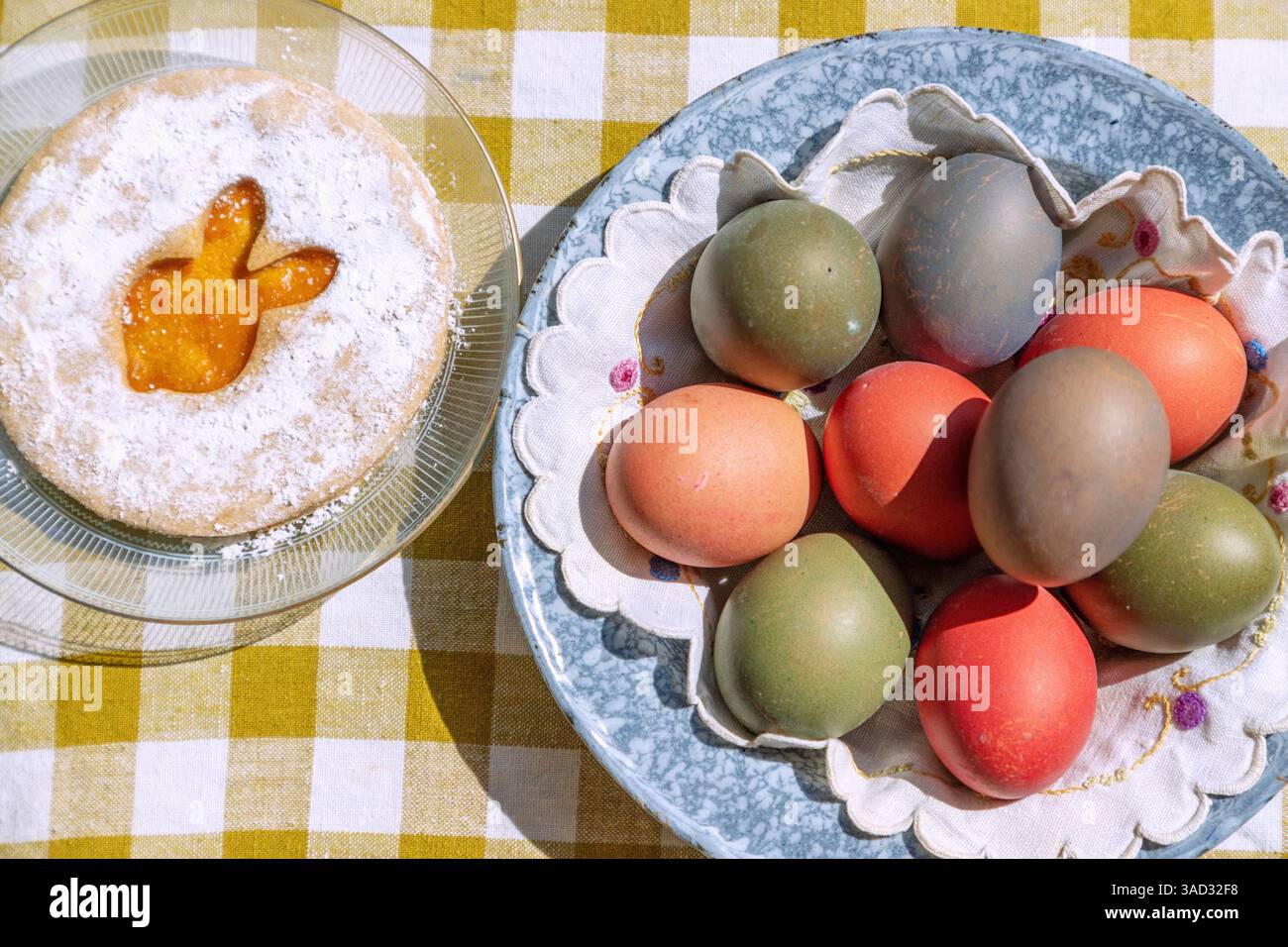 Easter cookie with Easter bunny motif with colorful Easter eggs on table with checkered tablecloth Stock Photo