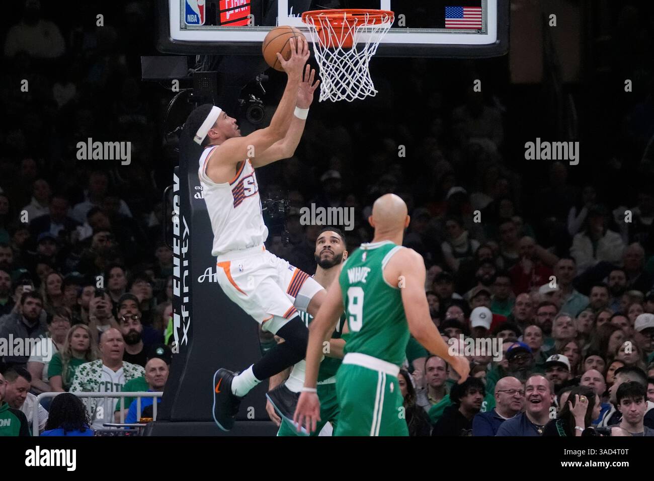 Phoenix Suns guard Devin Booker, top, drives to the basket against the