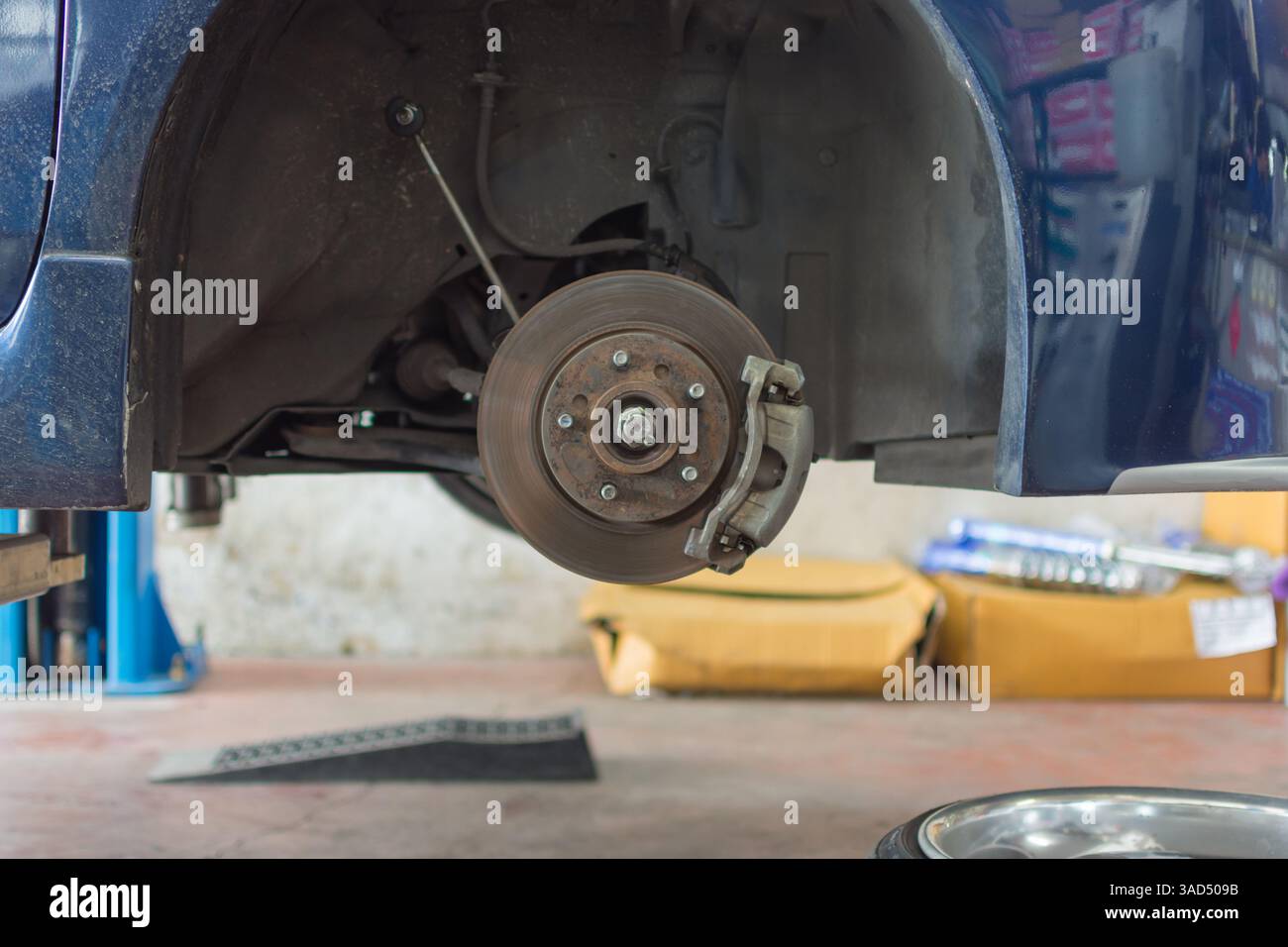 Checking car brake and suspension system in a car for repair at garage ...
