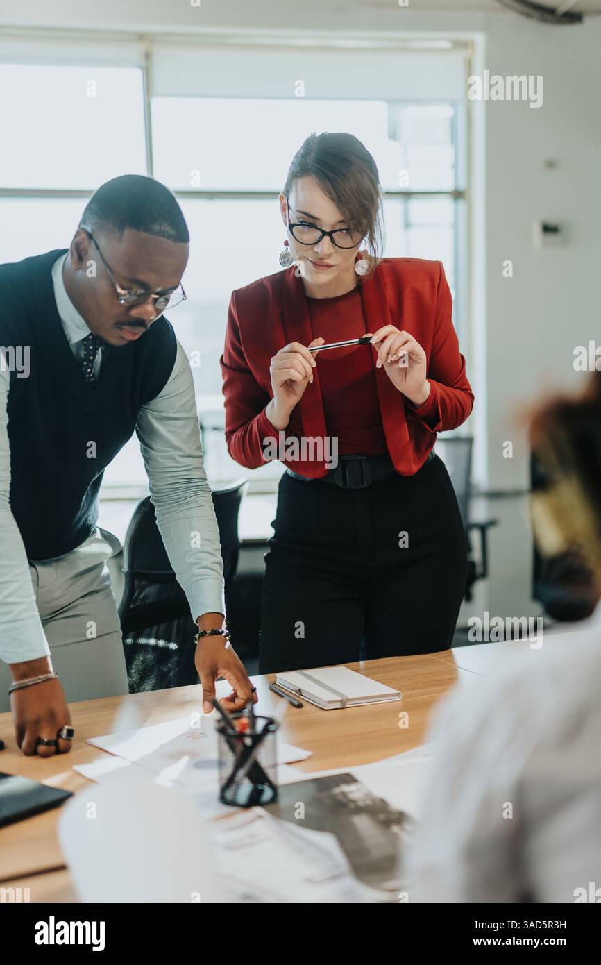 Multiracial business team brainstorming and analyzing project documents Stock Photo