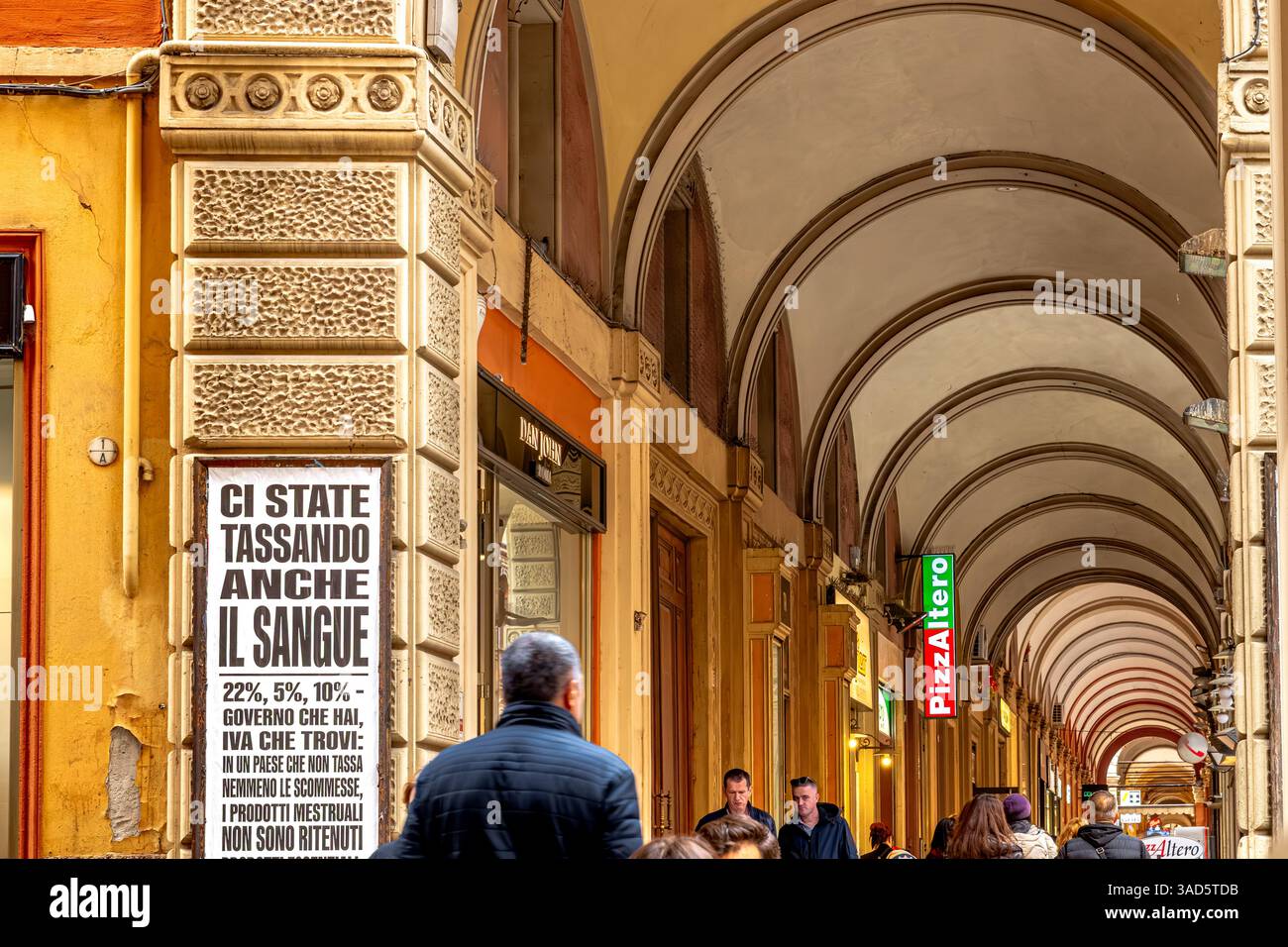 people-walking-through-the-elegant-portico-on-via-dell-indipendenza-in