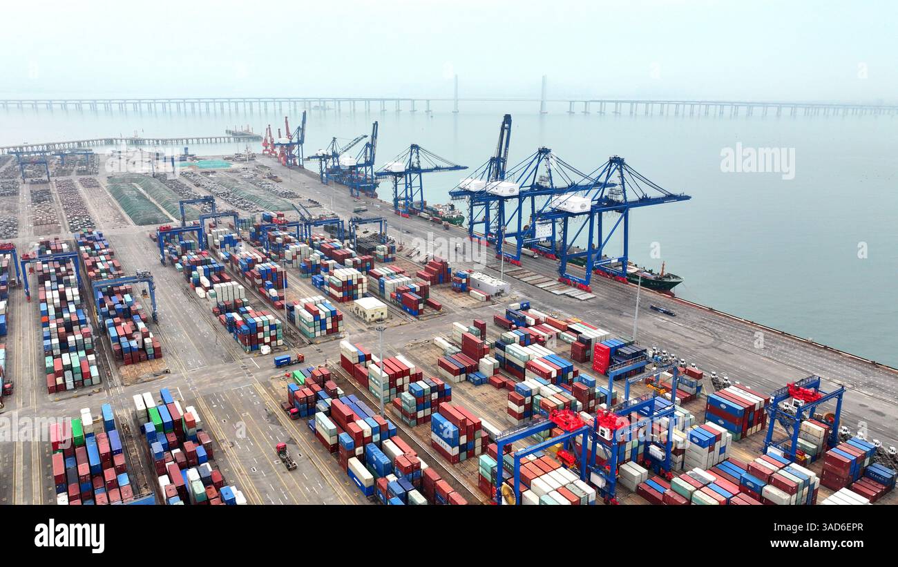 SHISHI, CHINA - APRIL 5, 2025 - Cargo ships load and unload containers ... image.