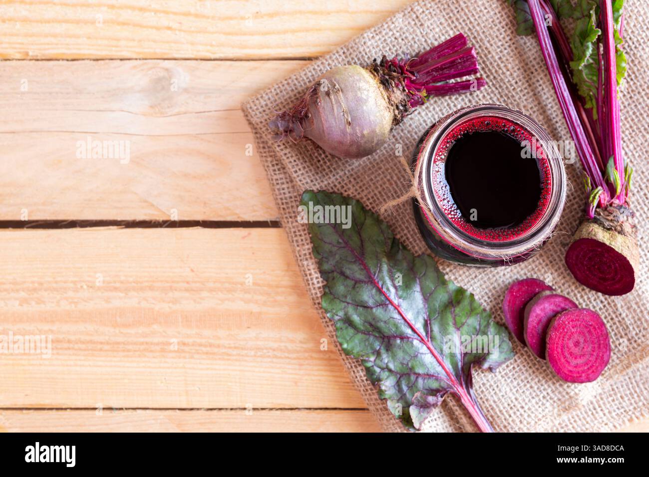 Freshly made beet juice on wood table. Space for text Stock Photo