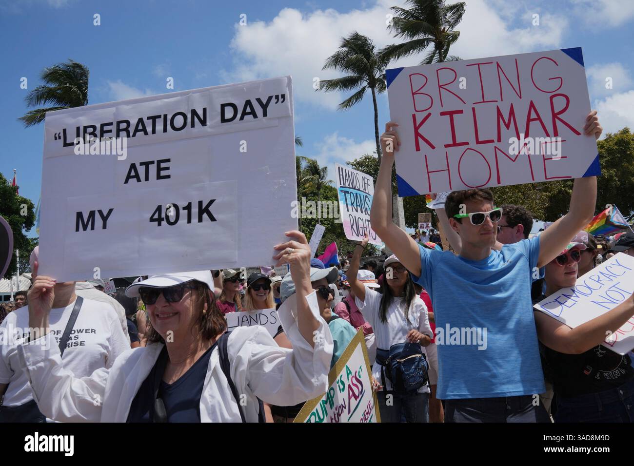 Protesters carry signs and chant slogans against the policies of ...