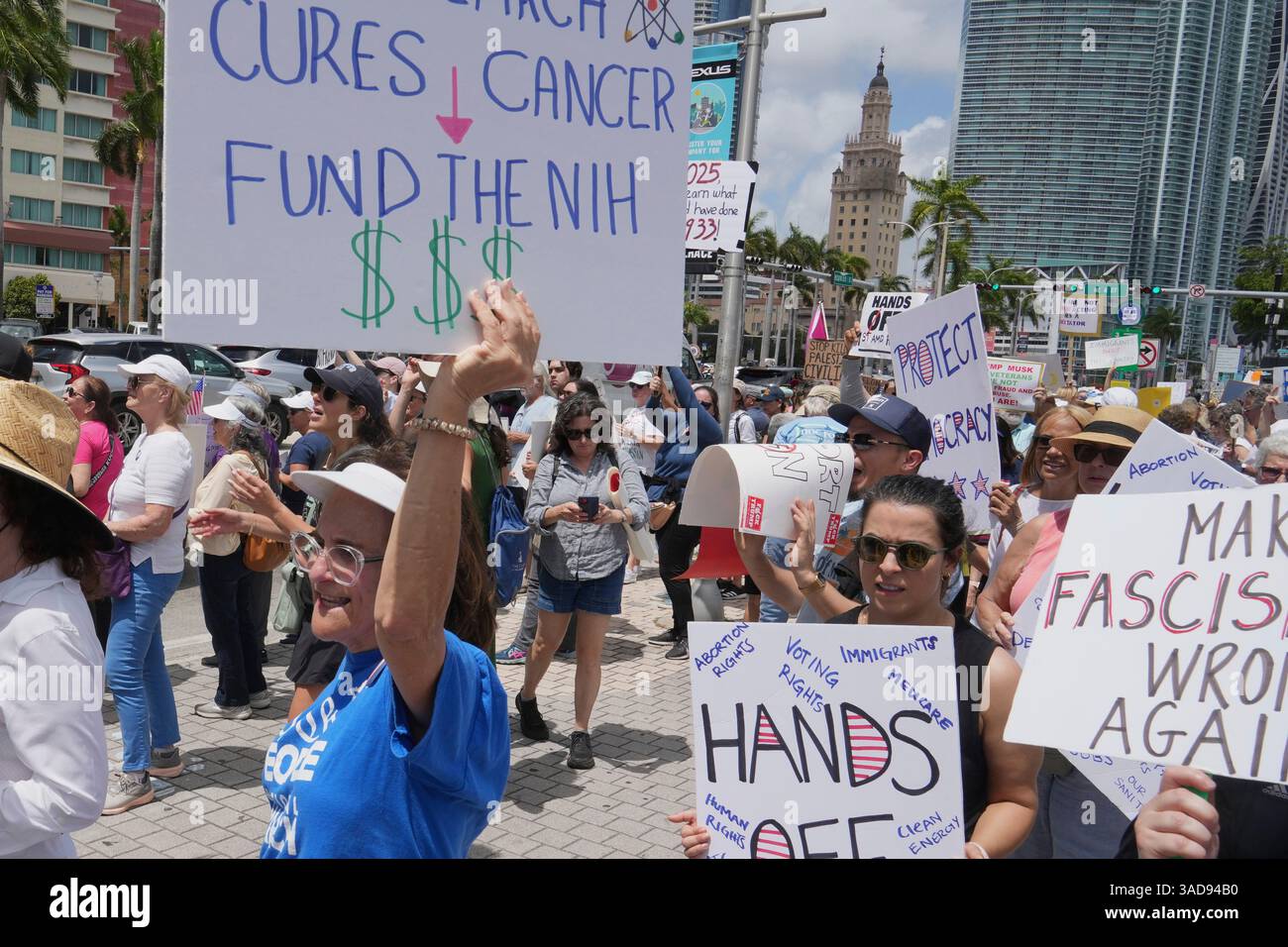 Protesters carry signs and chant slogans against the policies of ...